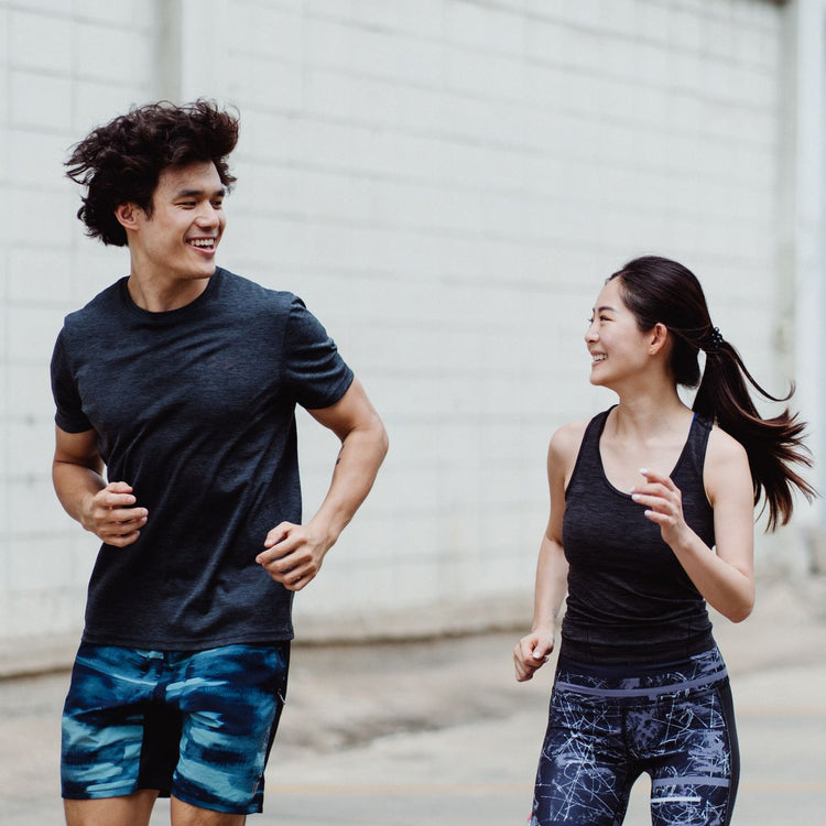 Couple jogging together outdoors, shop all departments