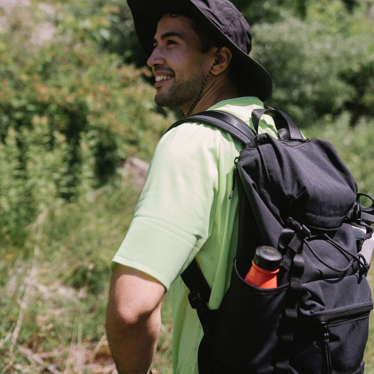 Active adult hiking outdoors with a backpack, representing Gummies & Chewables