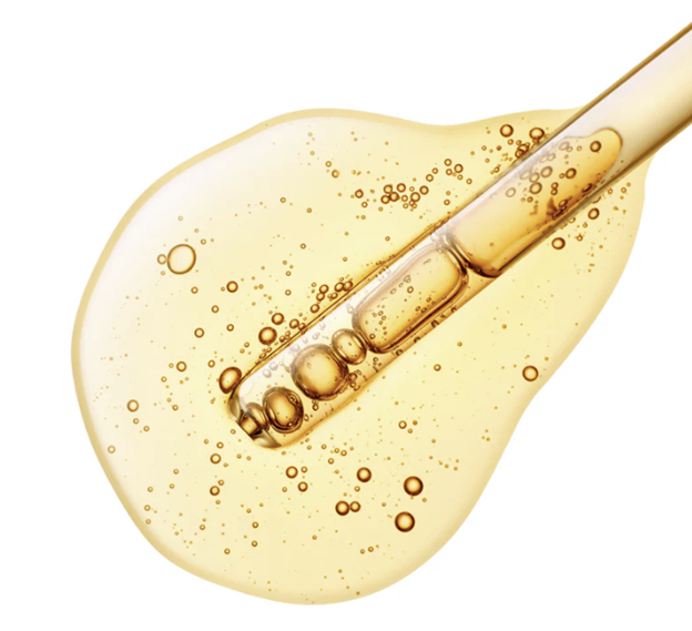 Natural Extract Fresh Layer Serum, a golden liquid with bubbles, being dispensed by a glass dropper.